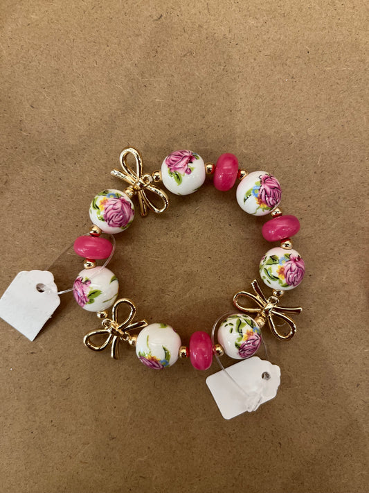 Pink beaded gold bowed bracelet